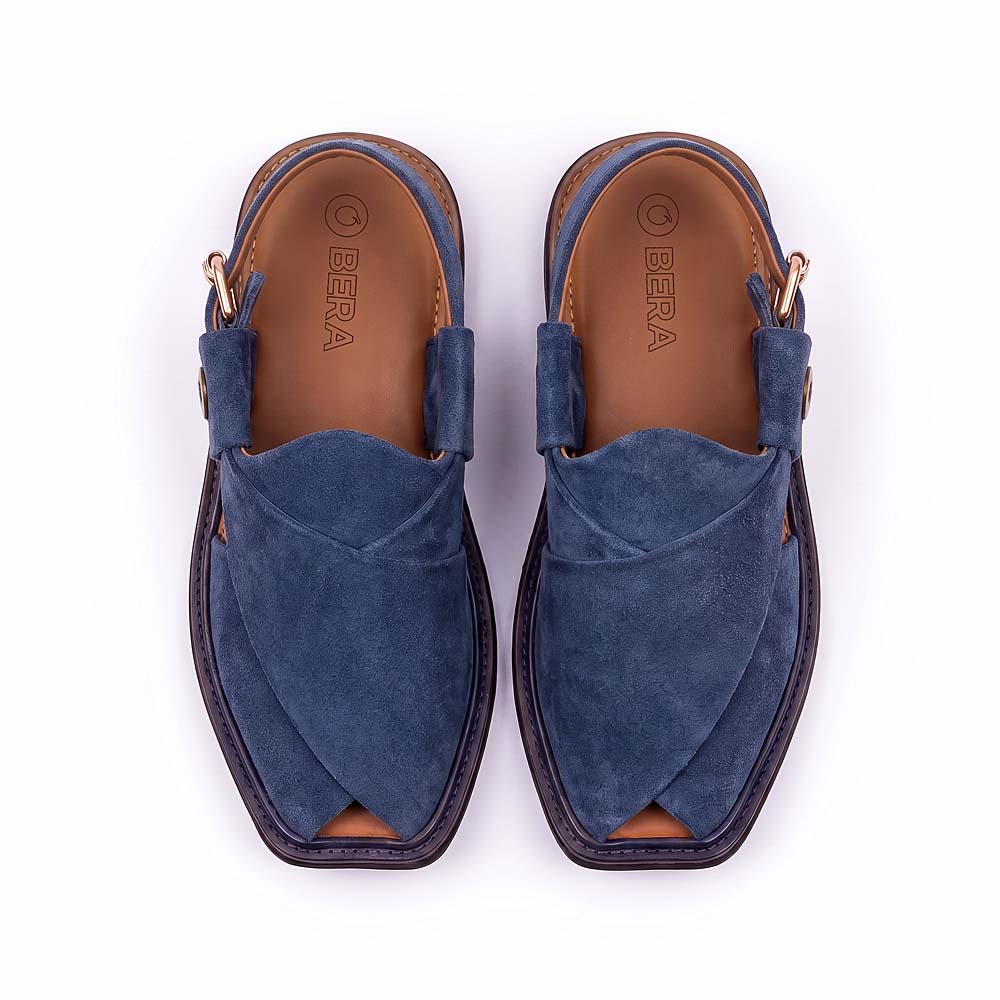 blue suede Charsadda Chappal pair shown from above with crossed suede straps, open toes and adjustable buckle straps