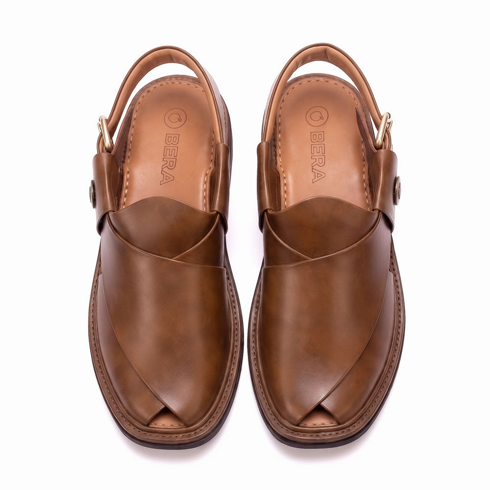 brown round shape Peshawari Chappal pair shown from above with overlapping leather straps and adjustable back buckles