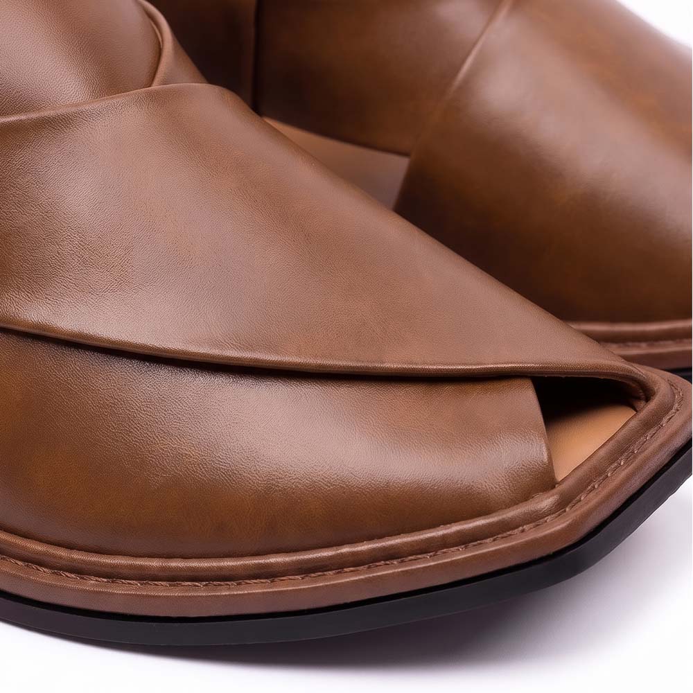 close-up of brown traditional Peshawari Chappal showing smooth leather panels, layered upper and detailed sole stitching
