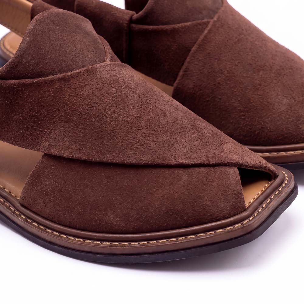 close-up of brown suede Peshawari Chappal showing textured upper and detailed stitching around the layered sol
