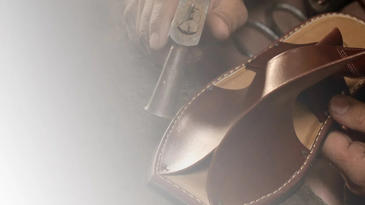 A man crafting Bera  Peshawari Chappal