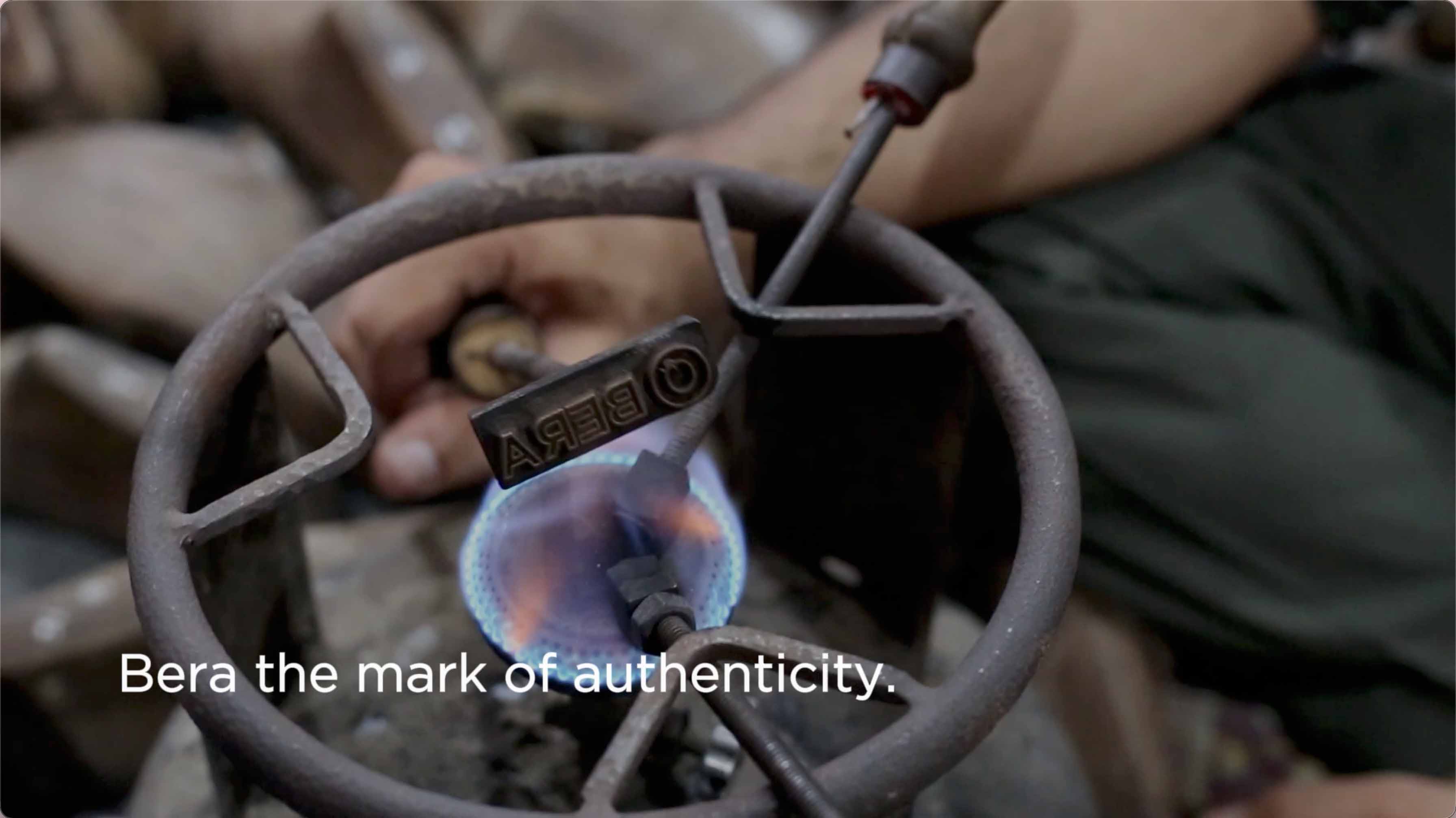 A close-up shot of a person heating a metal piece with a gas torch, the brand name 'BERA' clearly engraved on the metal. The tagline reads: 'BERA — the mark of authenticity.