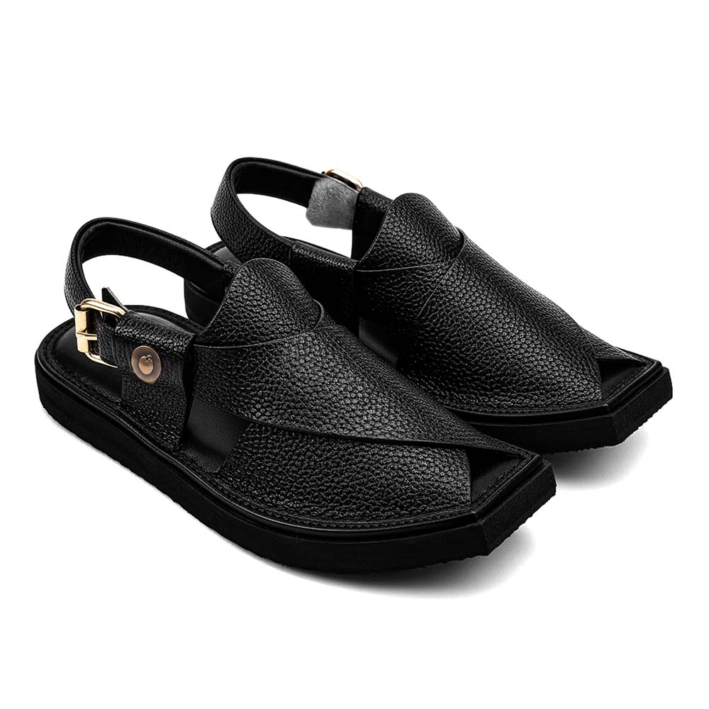 black Dot Khan Chappal pair shown from a three-quarter front view with textured leather straps and buckle closures