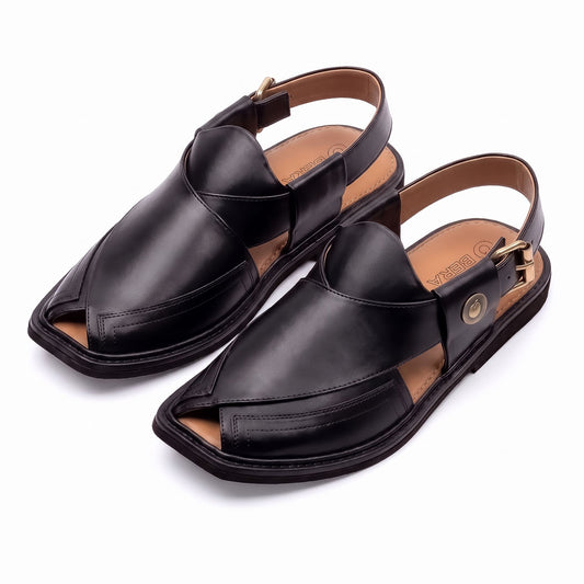 black Taki Chappal pair shown from a three-quarter front view with traditional leather straps and adjustable back straps