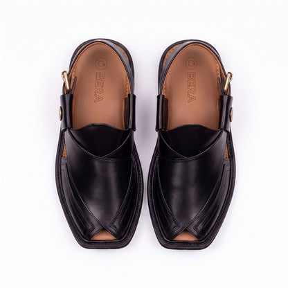 black Taki Chappal pair shown from the top with layered leather straps and tan branded insoles