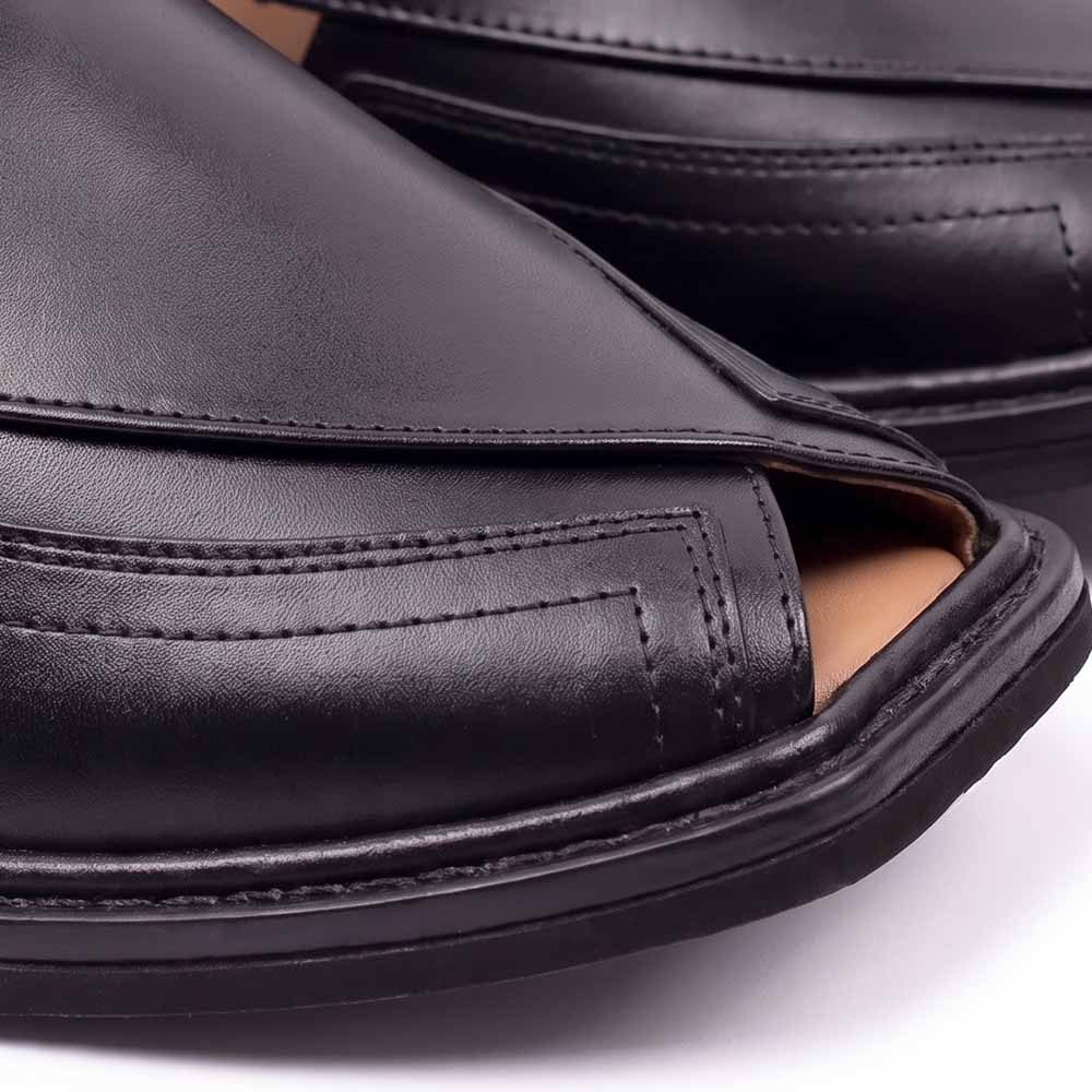 close-up of black Taki Chappal showing smooth leather panels, detailed stitching and layered black sole