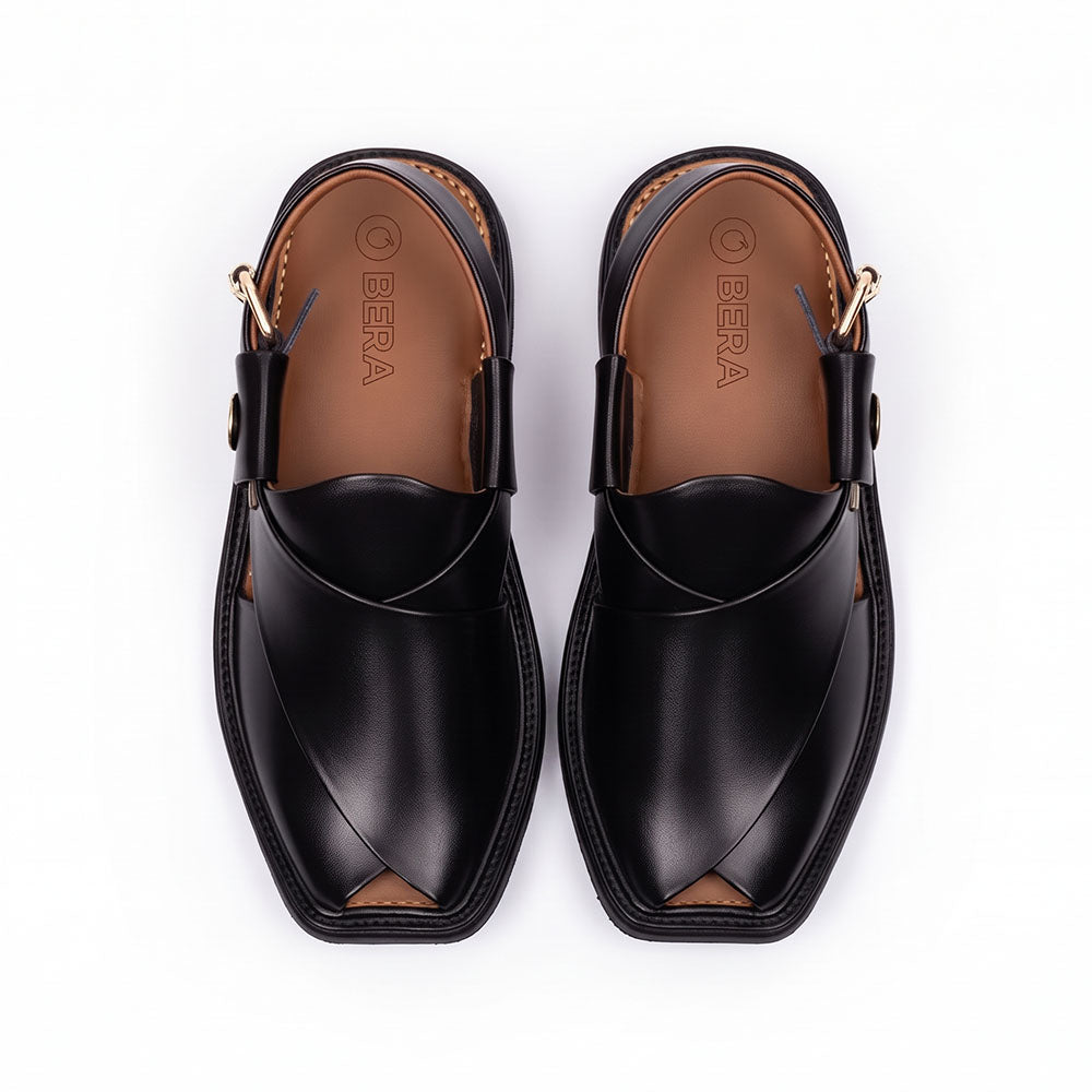 Black traditional Peshawari Chappal shown from the top with overlapping leather straps and a branded insole