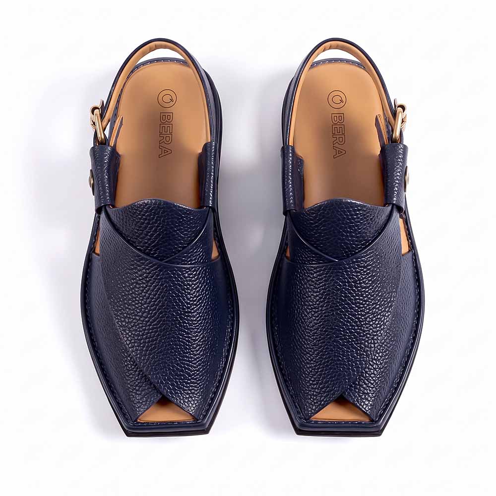 dark blue leather Peshawari Chappal pair shown from above with overlapping leather upper and side buckle straps