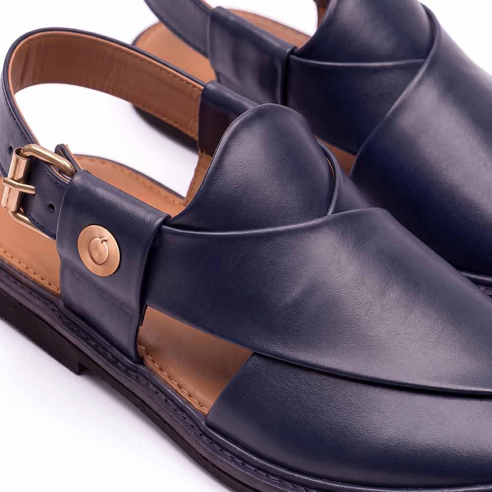 close-up of dark blue Peshawari Chappal showing the leather upper, buckle strap and gold-toned button detail