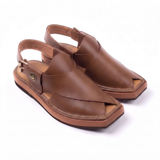 brown Kaptaan Chappal pair shown from a three-quarter front view with closed leather uppers, side buckles and stitched soles