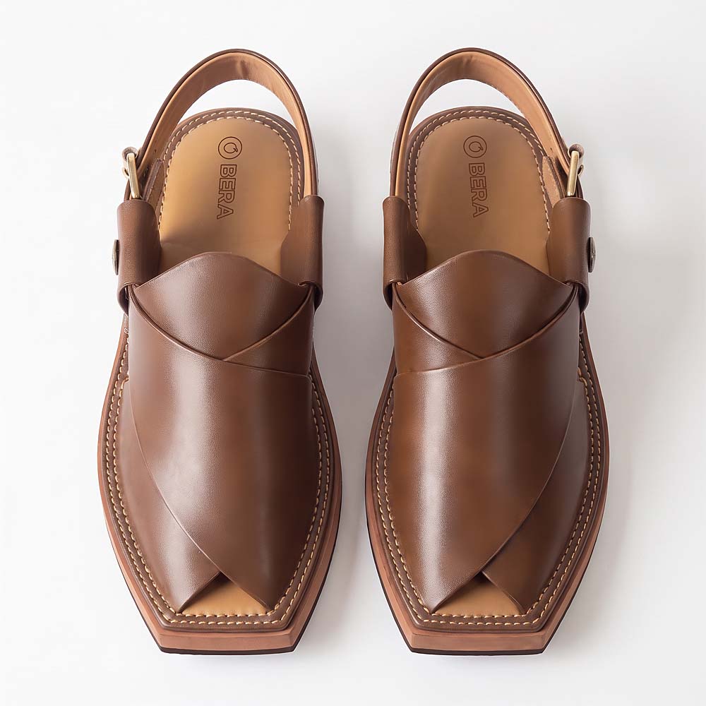 brown Kaptaan Chappal pair shown from above with wide overlapping leather straps and open pointed toes