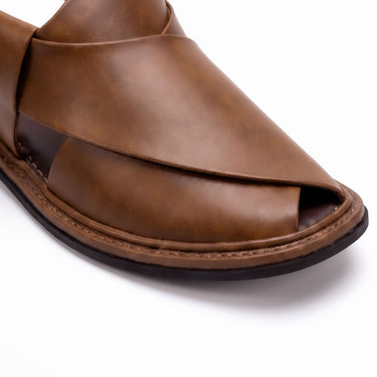 close-up of brown round shape Chappal showing smooth leather upper, open toe and stitched leather sole