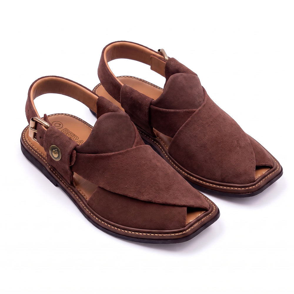 brown suede Peshawari Chappal pair shown from a three-quarter front view with crossed suede straps and adjustable heel buckles