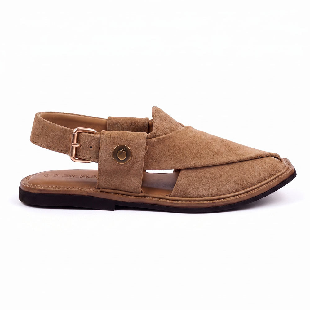 camel suede Peshawari Chappal shown from the side with crossed leather straps, buckle closure and stitched sole